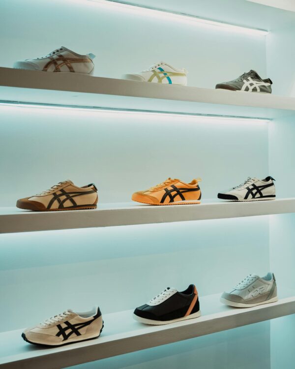 A sleek display of various sneakers on shelves in a Mexican retail store, showcasing modern sportswear.