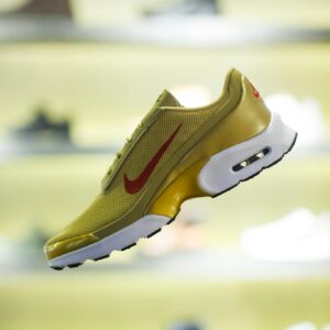 Stylish yellow sneaker showcased with blurred store background for a trendy vibe.